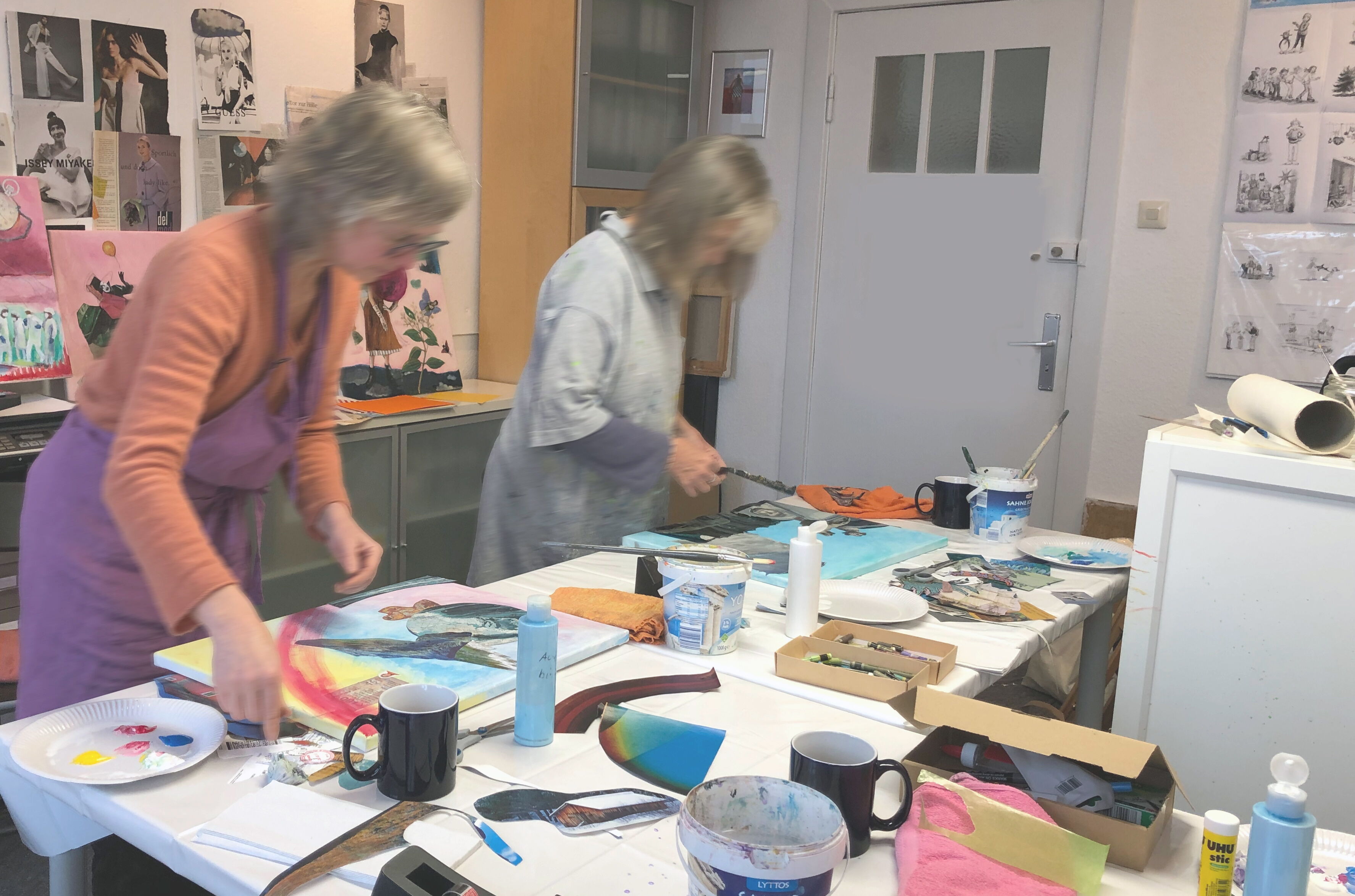 Zwei Frauen arbeiten kreativ während eines Kunst-Workshop an einem Collage-Bild im Atelier der Malerin und Illustratorin Edda Skibbe auf dem Kieler Seefischmarkt.